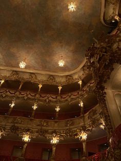 an ornately decorated auditorium with chandeliers and lights