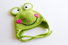 a crocheted frog hat with eyes and nose