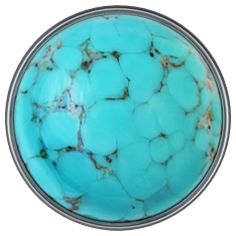 a round turquoise colored object with white trim