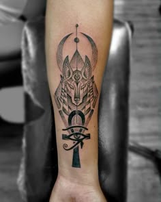 an egyptian tattoo on the arm