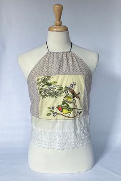 Vintage textile bird design halter top with white lace hem. Patchwork Tank Top For Beach In Spring, Spring Halter Neck Top With Crochet Trim, Sleeveless Lace Patchwork Crop Top For Spring, Summer Cotton Halter Top With Crochet Trim, Spring Halter Top With Crochet Trim, Spring Cotton Halter Top With Crochet Trim, Summer Cotton Tops With Bird Print, Spring Cotton Tank Top With Patchwork, Sleeveless Summer Crop Top With Patchwork