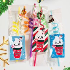 three candy lollipops in cello bags with christmas decorations on the top and bottom