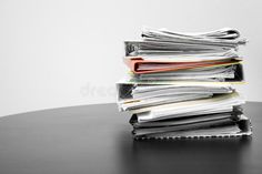 a stack of papers sitting on top of a table