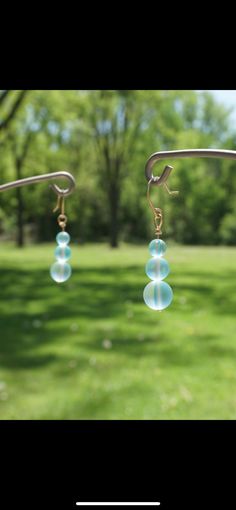 These blue water drop earrings are made with sterling silver or 14K gold wire. It is beautiful and the perfect length for face framing. These earrings are my go-to pair for my doubles. They catch the light subtly which draws attention in the best way. Blue Drop Earrings Hypoallergenic, Iridescent Wire Wrapped Drop Earrings, Light Blue Hypoallergenic Drop Earrings, Hypoallergenic Light Blue Drop Earrings, Clear Blue Water, Hypoallergenic Earrings, Face Framing, Gold Wire, Water Drop