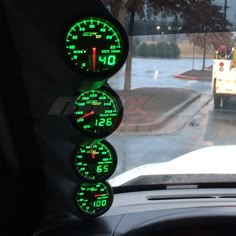 there are three speedometers on the dashboard of a car