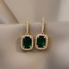 * New Emerald Green Crystal Elegant Square Gold Cubic Zirconia Diamond Earrings * Boutique Item * Unique, Delicate, And Trendy * Color: Gold * High Quality Materials And Premium Plating Process * All Jewelry Items Come With A Cleaning / Ponishing Cloth * Bundle And Save! Other Listings: Silver Gold Pearl Necklace Earrings Bracelet Engagement Ring, 925 Sterling Silver, S925 Silver, Vintage Style, Modern, Punk, Chunky, Minimal, Simple, Classic, Trendy, 925 Gold Ring, Adjustable Open Ring, Cute, Ch Emerald Earrings Drop, Art Deco Earrings, Emerald Earrings, Diamond Drops, Diamond Drop Earrings, Crystal Drop Earrings, Rhinestone Earrings, Green Crystals, Pearl Drop Earrings