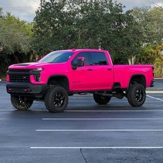 a pink truck parked in a parking lot