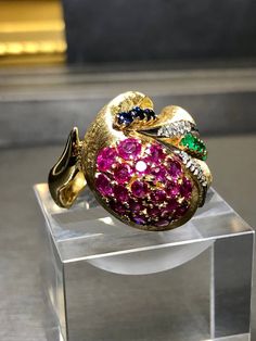 An absolutely fabulous free form design cocktail ring by none other than than one of our favorite American jewelry houses, Spitzer + Furman (signed and numbered). It has been hand crafted in 18K yellow gold and set with approximately 2.30cttw in rubies, .20cttw in sapphires and .30cttw in emeralds as well as .14cttw in G-H color Vs1-2 clarity round diamonds. Dimensions/Weight: Ring measures .90" in diameter and weighs 13.1g. Size 5.75 (sizable). Condition: All stones are secure and all makers ma Yellow Gold Multi-stone Rings For Party, Yellow Gold Multi-stone Ruby Ring, Multi-stone Ruby Ring In Yellow Gold, Unique Multi-stone Ruby Ring In Yellow Gold, Unique Yellow Gold Party Ring, Unique Yellow Gold Ruby Ring, Ruby Emerald, Form Design, Absolutely Fabulous