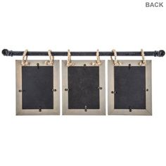 three metal frames hanging on a rope with blackboard attached to the wall and gold chain