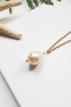 A rustic but elegant baroque pearl necklace that is perfect worn on it's own or layered with other necklace. This freshwater pearl necklace is very versatile and perfect for bother casual and formal occasions. Gold Pearl Pendant Necklace In 14k Gold Filled, Gold Baroque Pearl Necklace With Delicate Chain, Delicate Gold Baroque Pearl Necklaces, Delicate Baroque Pearl Necklace For Gifts, Delicate Baroque Pearl Necklace Gift, Handmade Dainty Baroque Pearl Necklaces, Minimalist Baroque Pearl White Necklace, Dainty Baroque Pearl Necklace For Gifting, Dainty Baroque Pearl Necklace For A Gift