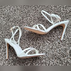 Lulus Lianya Style White Stiletto Heels Vegan Leather Ankle Strap Buckle Closure Heel Height 4 Inches Imperfections: Yellow Glue On The Edges Of Insoles; Not Visible When Worn Comes With Original Box White Strappy Heels With 4-inch Heel, White High Heel Strappy Heels, Wedding Heels With Wrapped Heel And Strappy Design, Wedding Strappy Heels With Wrapped Heel, Strappy Pointed Toe Synthetic Heels, Pointed Toe Heels With Straps In Synthetic Material, Synthetic Pointed Toe Heels With Straps, Synthetic Heels With Straps And Pointed Toe, Strappy Heels With Padded Heel For Wedding