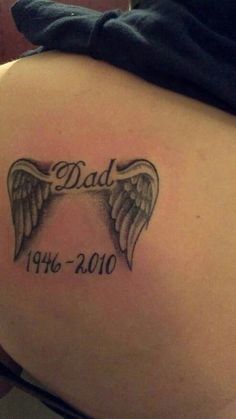 the back of a woman's stomach with an angel wing tattoo on it that says dad