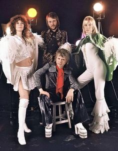 the group of women are posing for a photo in front of their mannequins