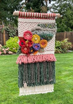 a large piece of art made out of yarn and flowers