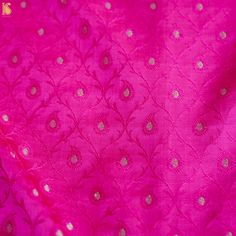 pink and gold brocaded fabric with white dots on the border, close up