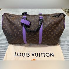 Beautiful Pop Of Bright Purple Accents Elevate This Classic Lv Keepall With An Upgraded Bandolier And Black Hardware In Mint Condition. Designer Travel Bag With Logo, Luxury Purple Rectangular Bag, Designer Purple Bags With Handles, Luxury Purple Tote Shoulder Bag, Luxury Purple Bags For Everyday Use, Purple Bag With Luggage Sleeve For Everyday Use, Luxury Bags With Logo For On-the-go, Luxury Purple Tote Bag, Luxury Purple Shoulder Bag For On-the-go