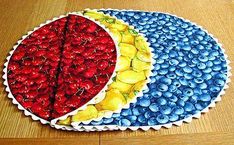 two pies decorated with fruit are on the table