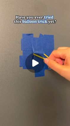 someone is holding a piece of blue paper with the words have you ever tried this button trick yet?