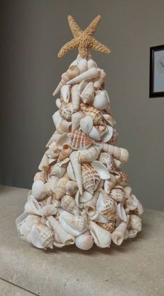 a christmas tree made out of seashells and starfish