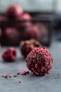 a close up of some kind of food on a table with raspberries in the background