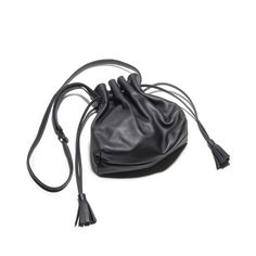 Indulge in luxury with the Lala Black Drawstring Bag. Crafted from smooth leather and lined with fabric, this bag boasts a tassel detail and round knotted straps. Practical and versatile, it seamlessly blends elegance and timelessness for the ultimate accessory. Elevate your style today. Chic Daily Use Bucket Bag With Tassels, Leather Bucket Bag With Tassels For Travel, Story London, Elevate Your Style, Smooth Leather, Drawstring Bag, Tassels, Shoe Bag, Handbags