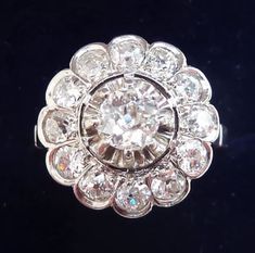 Date made: 1930's Diamond content: 0.84ct Metal: platinum Finger length 14mm Condition: Excellent commensurate to it's age Ring Size: UK/AUS I1/2   US/CAN 41/2  can be resized This beautiful antique ring originates from the 1930's. The ring showcases a gorgeous 5mm/0.45ct old cut diamond. Accompanying the central diamond are a further 12 matching 2mm/0.03ct old cut. These SI clarity H colour dazzling diamonds that offer a fabulous flash and total 0.84ct. The shank is solid platinum with french h Antique Rings Vintage, Period Pieces, Antique Jewellery Online, Antique Ring, Gorgeous Art, Engagement Anniversary, Antique Jewellery, Antique Rings, Cluster Ring