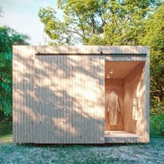 a wooden sauna in the middle of a field