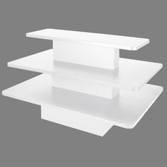 three white shelves stacked on top of each other