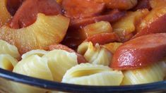 pasta with sausage and pineapple slices in a glass bowl