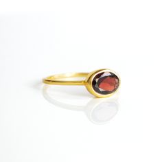 You'll fall in love with the deep red coloring of this Garnet ring. This is a perfectly sized oval to compliment any collection. Popular as a birthday gift for those January babes and Garnet lovers alike. This is a dark, transparent red gemstone with no flaws. This stone is beautifully faceted and bezel set in a 925 sterling silver band or plated with 18k vermeil gold. Gemstone is approximately 8 x 6mm.Band has 925 stamp on inside.Please note that each ring is handmade and there may be some slig Bezel Ring, Red Gemstones, January Birthstone, Garnet Ring, Garnet Rings, Sterling Silver Bands, The Deep, Silver Band, Deep Red