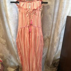 Darling And Easy To Wear Jumpsuit From Anthropologie. Tie Front, Stripes. Full Length. Never Worn. Tassels Ties, Ruffled Neck. Pink Cotton Jumpsuits And Rompers For Vacation, Pink Cotton Jumpsuit For Vacation, Casual Overall Beach Dresses, Casual Beach Overall Dresses, Casual Overall Dress For Beach, Pink Beach Overalls Jumpsuit, Pink Overall Jumpsuit For Beach, Pink Beach Overall Jumpsuit, Pink One-piece Jumpsuit For Vacation