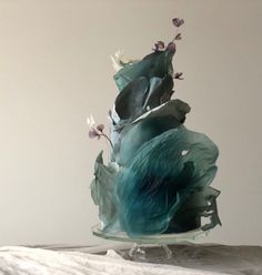 a glass vase filled with flowers on top of a table