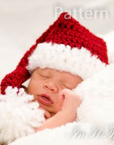 a newborn baby wearing a red and white santa hat