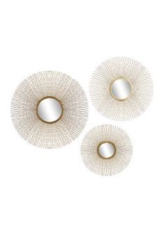 three white and gold circular mirrors on a white background, each with an intricate design