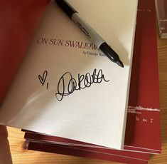 a pen is sitting on top of a piece of paper that has been signed onto