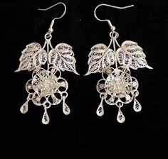 Beautiful vintage sterling silver filigree floral chandelier earrings  They measure: 2 inches long with a 2 1/2 inch drop counting the ear wires by 1 1/4 inch wide and weigh 8.8 grams combined  Screw backs have been replaced with sterling silver ear wires to accommodate pierced ears Silver Dangle Chandelier Earrings With Intricate Design, Victorian Silver Dangle Chandelier Earrings, Silver Victorian Dangle Chandelier Earrings, Traditional Silver Chandelier Earrings With Ear Wire, Handmade Silver Victorian Chandelier Earrings, Handmade Victorian Silver Chandelier Earrings, Floral Chandelier, Sterling Silver Filigree, Silver Filigree