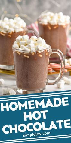 two mugs filled with hot chocolate and marshmallows