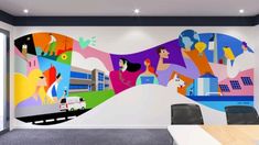 an office with a colorful mural on the wall