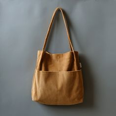 More Colors:  https://www.etsy.com/shop/Bokzim?search_query=double+pocket ------------------------------------------------------- Double Pocket Corduroy Tote Bag 👉 F E A T U R E S - Soft corduroy fabric  - Multi pockets  - 13" laptop fit in  - Magnetic closure - Handmade in Korea  [Large Capacity]: big enough to carry a 13" laptop and an A4 ring binder  [Multi compartments]: TWO exterior pockets and ONE inner pocket help organize your essentials effectively. [Material]: Feel the difference. Soft corduroy fabric is used. No smell of bad chemicals.  📏 D I M E N S I O N S Length: 13.3" (34cm) Height: 14.5" (37cm) Depth: 3.1" (8cm) Drop Length: 12.6" (32cm) Handmade in Korea  . Brown School Shoulder Canvas Bag, Daily Use Corduroy Canvas Bag With Pockets, Corduroy Canvas Bag With Pockets For Daily Use, Corduroy Canvas Shoulder Bag For Everyday Use, Daily Use Corduroy Shoulder Bag With Pockets, Everyday Corduroy Canvas Tote Bag, Everyday Corduroy Tote Canvas Bag, Daily Use Corduroy Canvas Bag, Corduroy Tote Canvas Bag For School