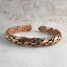 Introducing our Handmade Braided Bracelets, exquisitely crafted with love in Nepal by skilled artisans who have transformed our vision into a reality. Elevate your style with these timeless accessories that effortlessly blend the essence of hippie and boho aesthetics, meticulously created for the free-spirited souls. 🌿PRODUCT DETAILS: - Handcrafted in Nepal - Made from, Copper, Brass and Pewter (metal alloy made of tin, copper, antimony and sometimes silver) - Unisex design, perfect for all - Free size and Adjustable, ensuring a comfortable fit for everyone 🌿ONE-OF-A-KIND: Embrace the captivating allure of handcrafted treasures. Each bracelet is a unique masterpiece, meticulously crafted by skilled hands. These slight variations add to the charm, making your piece truly one-of-a-kind. GE Copper Jewellery, Tibetan Jewelry, Pewter Metal, Bangles Making, Timeless Accessories, Mens Accessories Fashion, Braided Bracelets, Copper Jewelry, Namaste