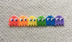 a row of colorful plastic beads sitting on top of a carpet