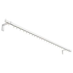 a white metal shelf with hooks on it