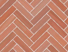 an orange and white herringbone tile pattern with some red paint on the top right corner