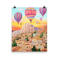 a painting of hot air balloons in the sky above a town with mountains and trees