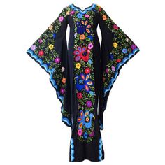 Black Floral Embroidered Beach Maxi Dress, Black Maxi-length Gown For Spring, Spring Black Maxi Gown, Fitted Embroidered Black Kaftan, Fitted Black Embroidered Kaftan, Black Long Sleeve Embroidered Gown, Black Embroidered Long Sleeve Gown, Black Maxi Dress With Floral Embroidery, Black Spring Kaftan For Evening Wear