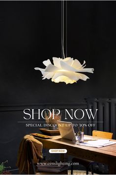 a table with a laptop on it next to a lamp that says shop now special discount up to 30 % off