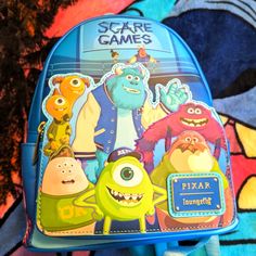 a blue backpack with monsters on it