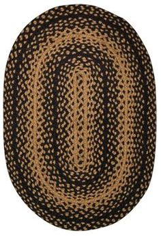 an oval rug with black and tan designs