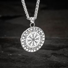 This stainless steel necklace is perfect for those who want to add a little bit of mythology to their wardrobe. The shield style pendant features the mythical serpent Jormungand, encircling a Valknut symbol. Whether you're dressing up for a day at the office or dressing down for a night out on the town, this necklace is sure to make a statement. Also features a Helm of Awe on the reverse with the inscription: "The brave shall live forever in the halls of Valhalla" Pendant is approx. 1.5" across Viking Style Silver Outdoor Jewelry, Outdoor Engraved Medallion Necklace, Viking Style Engraved Round Pendant Necklace, Viking Style Stainless Steel Necklace For Gift, Symbolic Tarnish Resistant Stainless Steel Necklaces, Symbolic Tarnish Resistant Stainless Steel Necklace, Symbolic Stainless Steel Tarnish Resistant Necklace, Nickel-free Stainless Steel Amulet Necklace, Silver Pendant Necklace For Outdoor