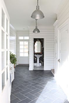 the front entrance to a house with tile floors